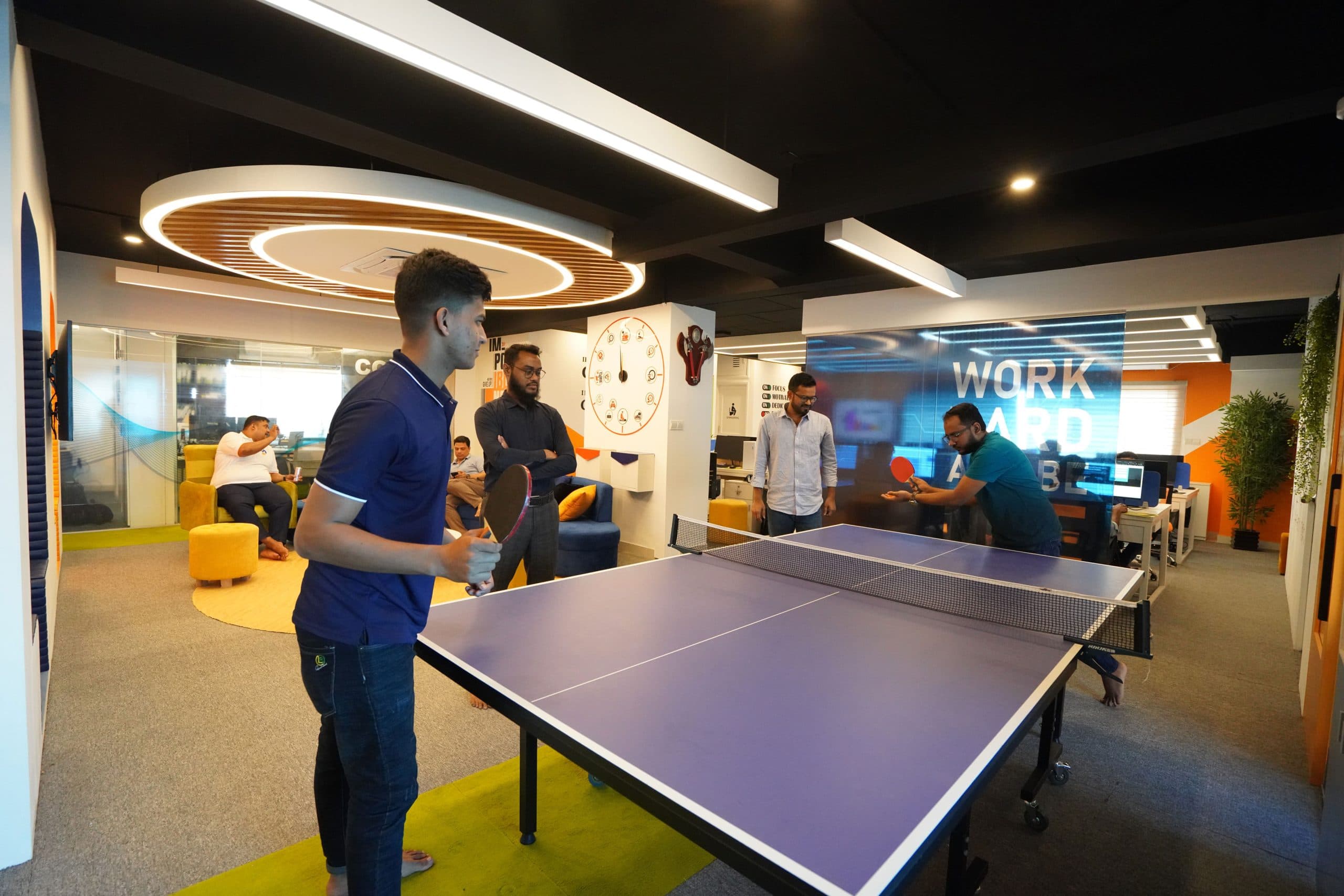 Team members enjoying a fun break with table tennis